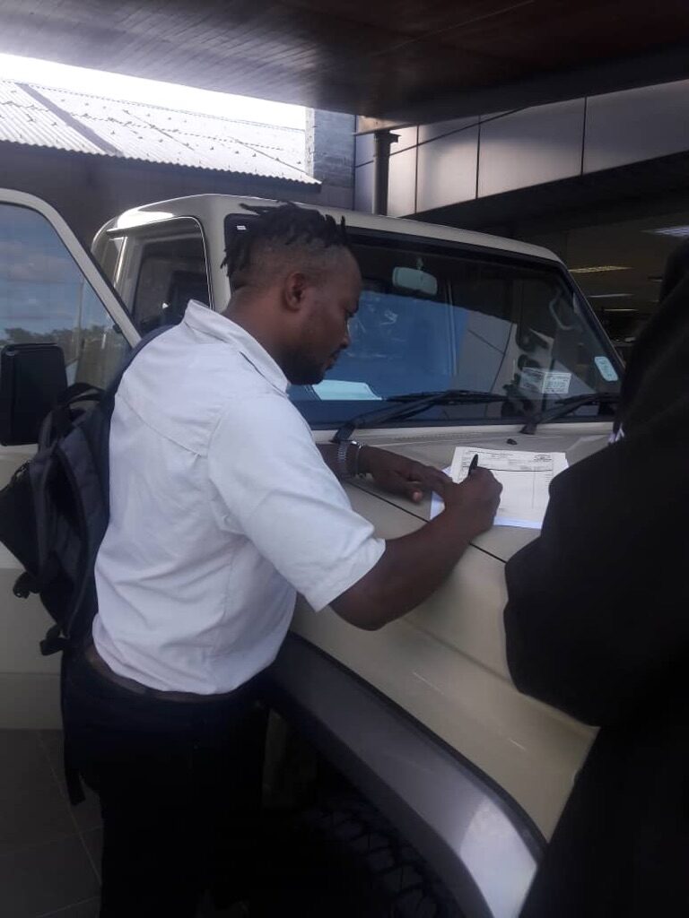 Signing the Papers for our Toyota Landcruiser